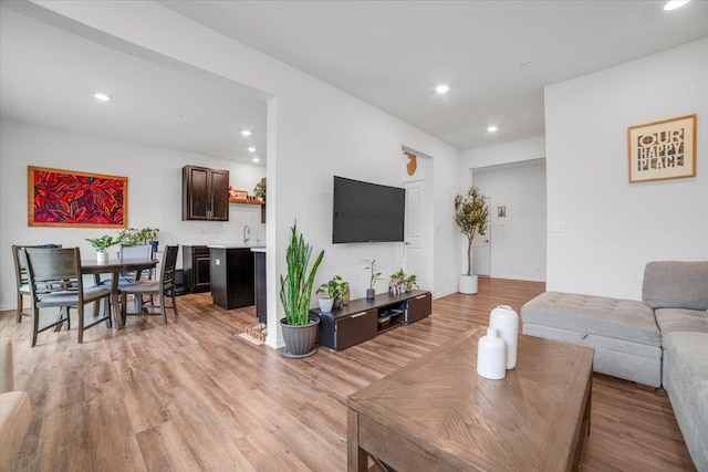 living room featuring light wood-style flooring and recessed lighting