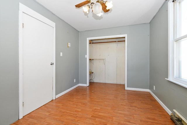2644 Commercial Ave, South Chicago Heights, IL 60411 - unfurnished bedroom featuring light wood finished floors, a closet, baseboards, and ceiling fan