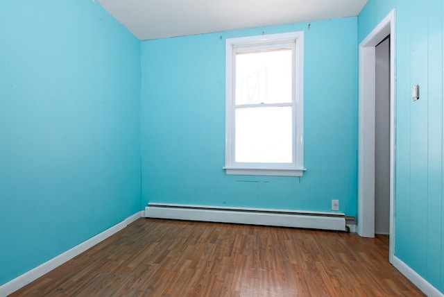 2644 Commercial Ave, South Chicago Heights, IL 60411 - spare room featuring baseboard heating, baseboards, and wood finished floors