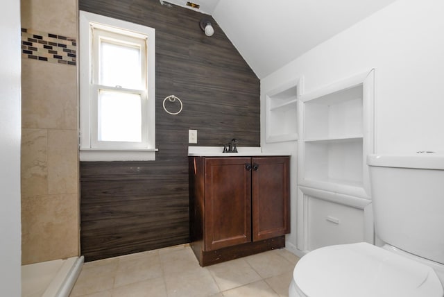 2644 Commercial Ave, South Chicago Heights, IL 60411 - bathroom featuring built in features, toilet, a walk in shower, vaulted ceiling, and tile patterned floors