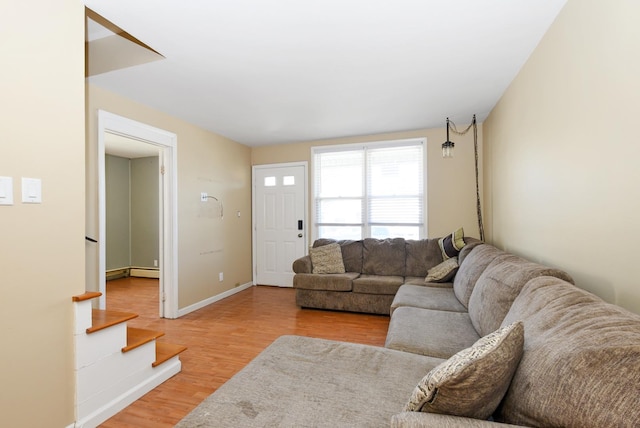 2644 Commercial Ave, South Chicago Heights, IL 60411 - living room featuring light wood-type flooring, baseboards, a baseboard radiator, and stairway