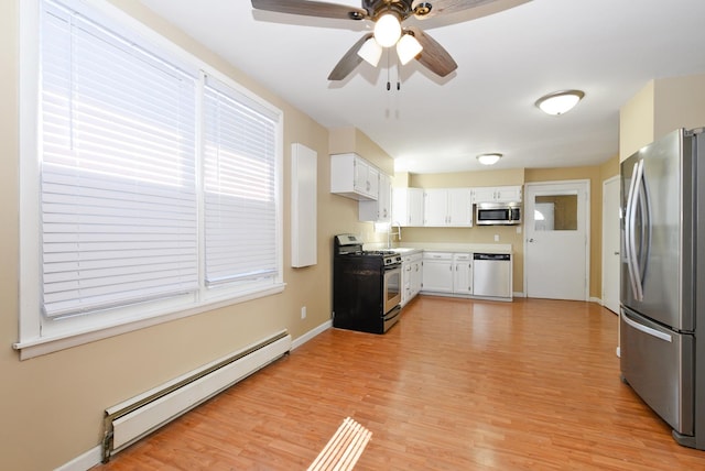 2644 Commercial Ave, South Chicago Heights, IL 60411 - kitchen featuring ceiling fan, white cabinetry, stainless steel appliances, light wood-style flooring, and a baseboard heating unit