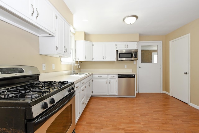 2644 Commercial Ave, South Chicago Heights, IL 60411 - kitchen featuring light countertops, appliances with stainless steel finishes, a sink, and white cabinetry