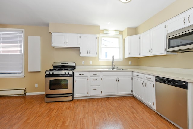 2644 Commercial Ave, South Chicago Heights, IL 60411 - kitchen featuring light wood-style floors, appliances with stainless steel finishes, a sink, and white cabinets