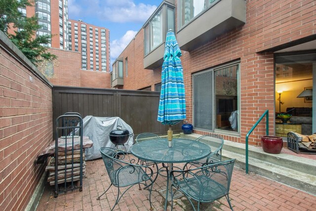 801 S Plymouth Ct Unit P, Chicago, IL 60605 - view of patio featuring outdoor dining space and fence
