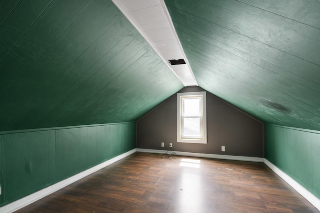 additional living space featuring lofted ceiling, baseboards, and wood finished floors
