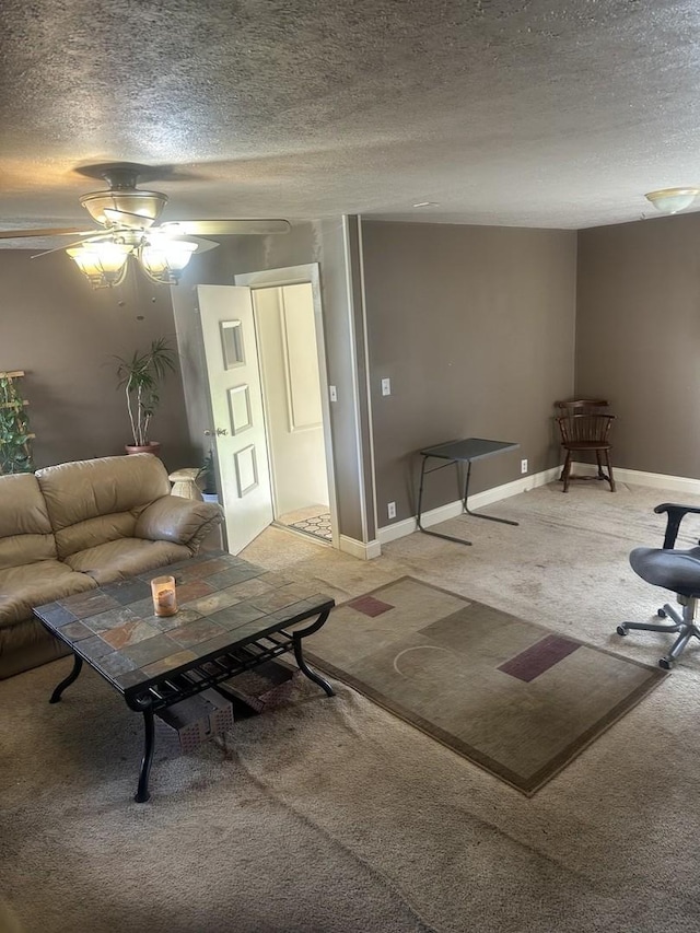living room with a textured ceiling, light colored carpet, ceiling fan, and baseboards