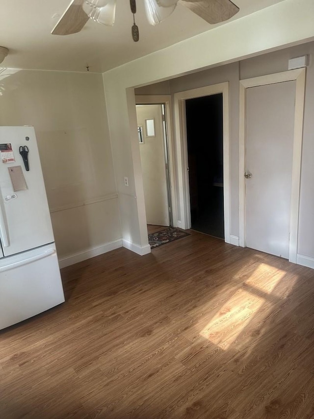 unfurnished room featuring baseboards, a ceiling fan, and wood finished floors