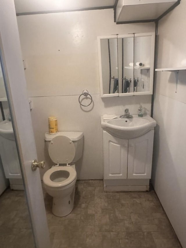 bathroom featuring toilet and vanity