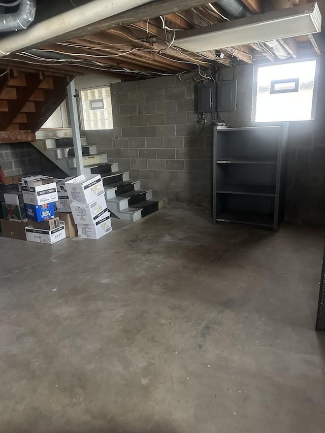 basement featuring stairway and electric panel