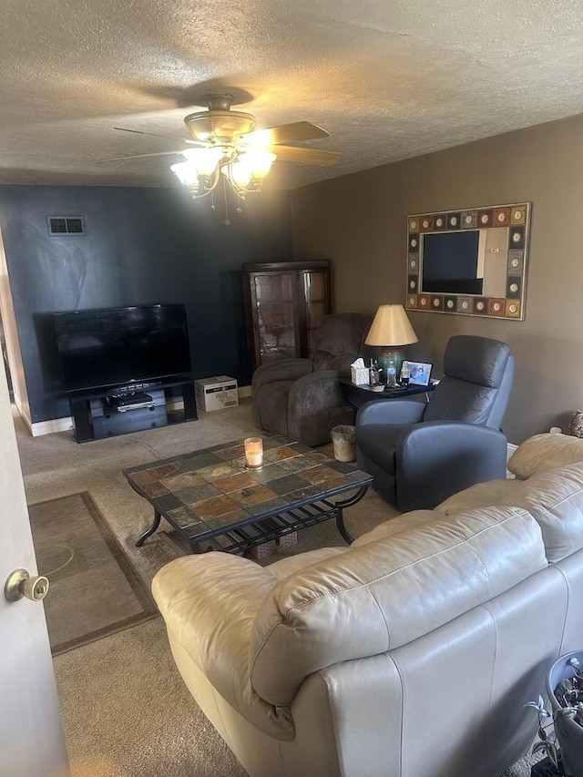 carpeted living room featuring a textured ceiling, ceiling fan, and visible vents