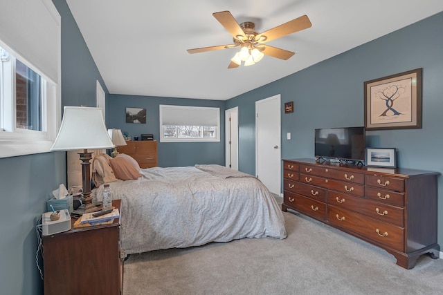 bedroom with ceiling fan and light carpet