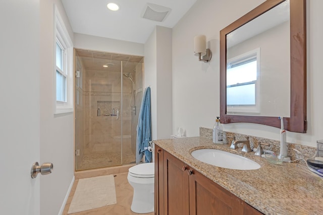 bathroom with vanity, toilet, baseboards, a shower stall, and visible vents