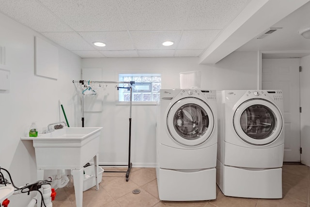 laundry area featuring light tile patterned floors, laundry area, visible vents, and washer and clothes dryer