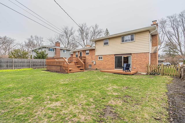 back of house featuring a fenced backyard, a chimney, a deck, and brick siding