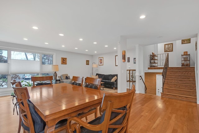 dining room featuring recessed lighting, stairway, and light wood-style floors