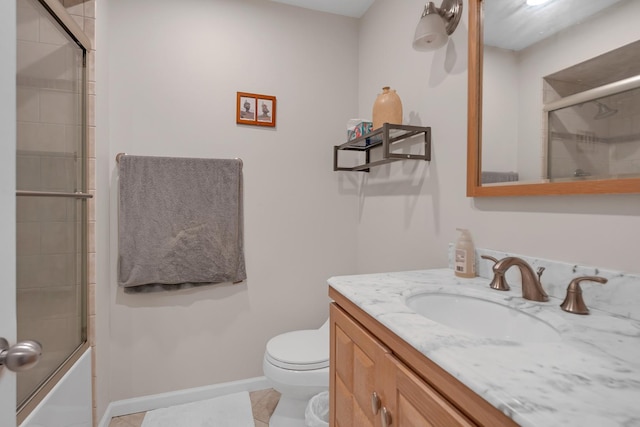 full bathroom with shower / bath combination with glass door, vanity, toilet, tile patterned floors, and baseboards