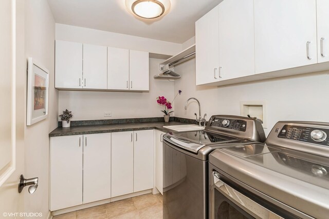 laundry room with washer and clothes dryer, a sink, and cabinet space