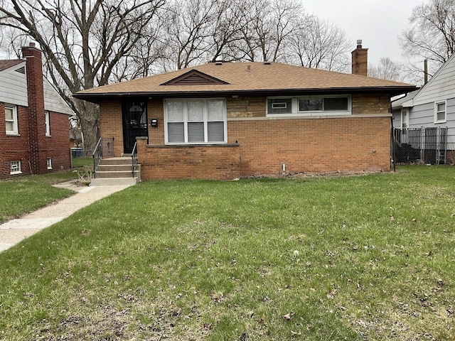 451 Clyde Ave, Calumet City, IL 60409 - view of front of house with brick siding, roof with shingles, a front lawn, and a chimney