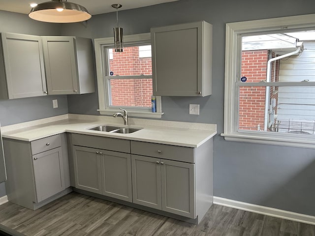 451 Clyde Ave, Calumet City, IL 60409 - kitchen featuring gray cabinets, a sink, and a wealth of natural light