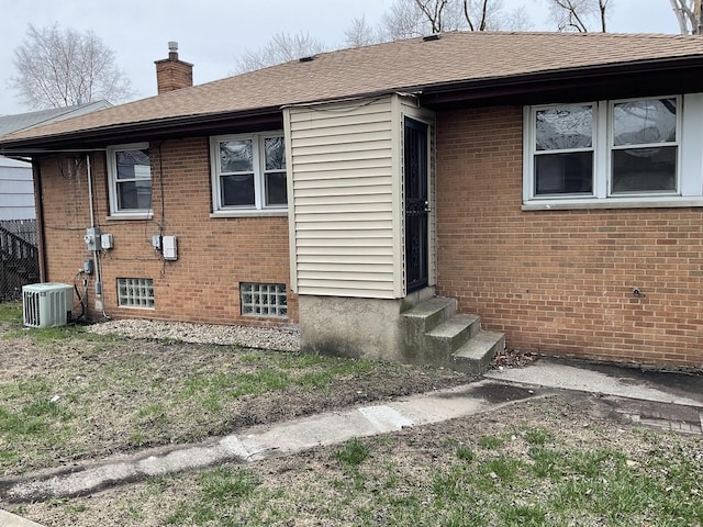 451 Clyde Ave, Calumet City, IL 60409 - exterior space with brick siding, cooling unit, and a chimney