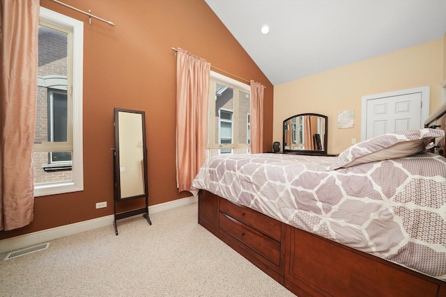 bedroom with visible vents, baseboards, lofted ceiling, and light colored carpet