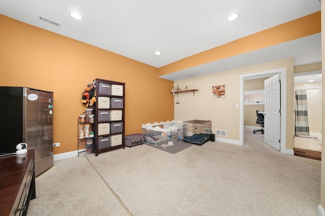 interior space with baseboards, visible vents, and carpet