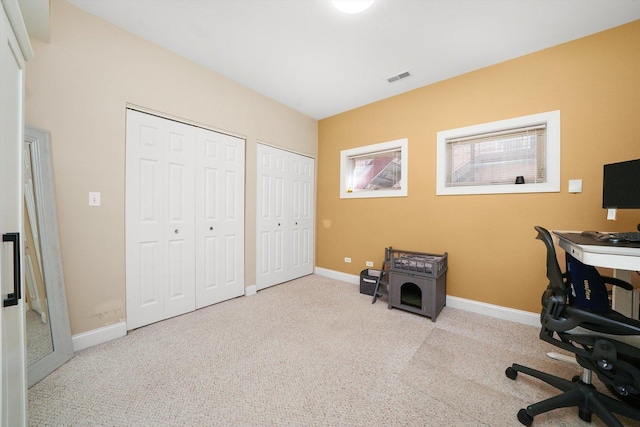 carpeted home office with baseboards and visible vents