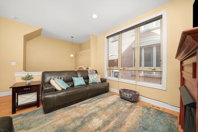 living area with recessed lighting, baseboards, and wood finished floors