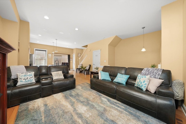 living area with recessed lighting and wood finished floors