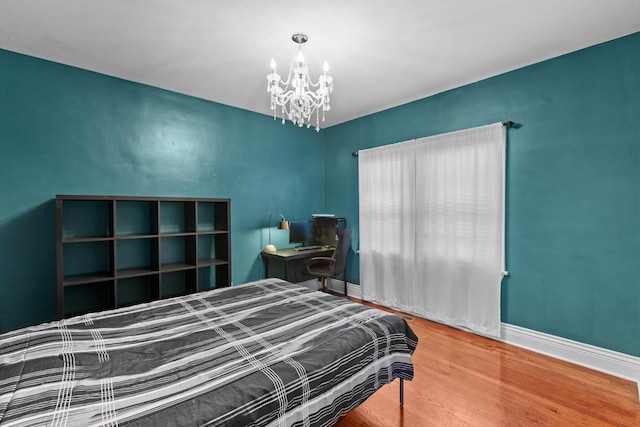 701 N 4th Ave, Maywood, IL 60153 - bedroom with wood finished floors, an inviting chandelier, and baseboards