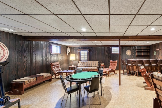 recreation room with wood walls, recessed lighting, and a bar
