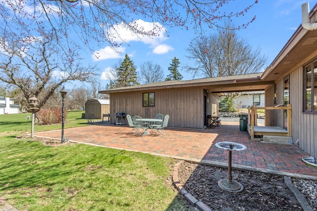 view of yard featuring a shed, a patio area, and an outbuilding