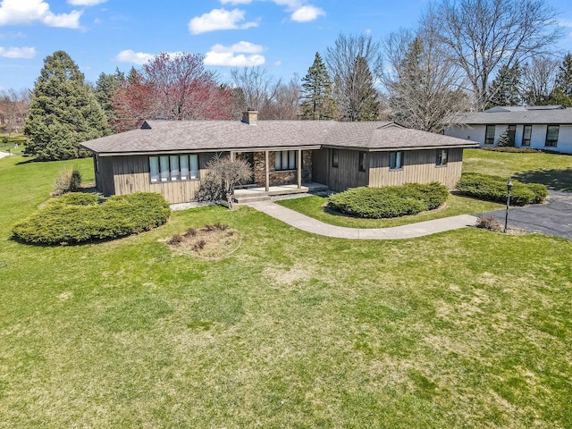 single story home featuring a front yard and a chimney