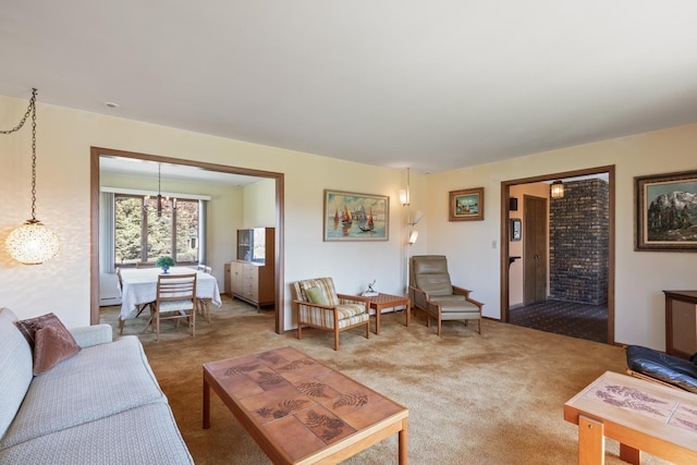 living area featuring an inviting chandelier and carpet floors