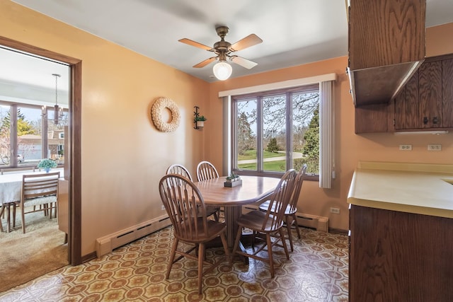 dining area with a baseboard radiator, baseboards, and a healthy amount of sunlight