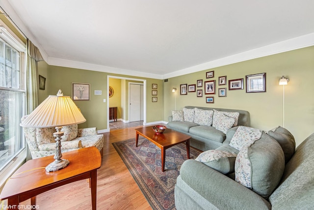living area with baseboards and wood finished floors