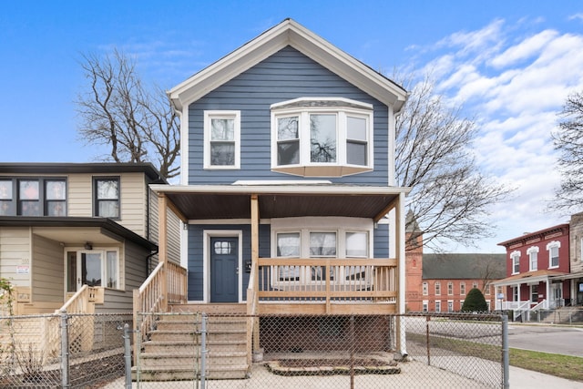 view of front facade featuring a porch and a fenced front yard