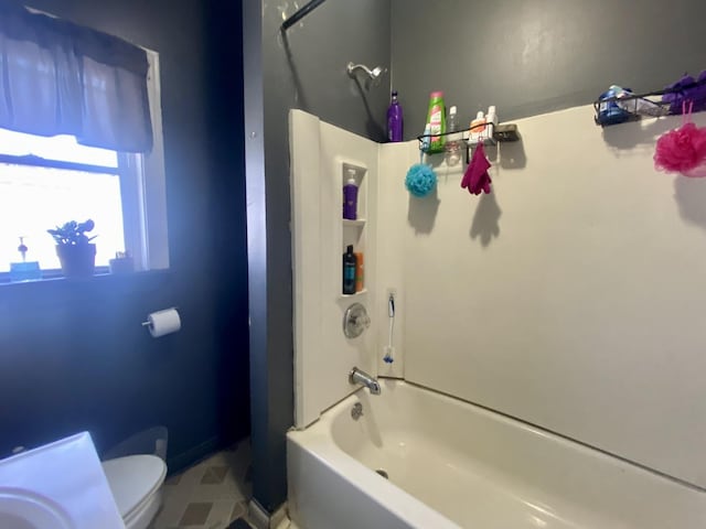 bathroom with tile patterned floors,  shower combination, and toilet