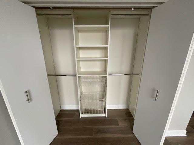unfurnished dining area with baseboards, dark wood-style floors, ceiling fan, and cooling unit