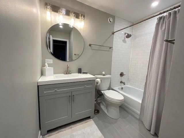 kitchen with a sink, dark wood-style flooring, and white cabinets