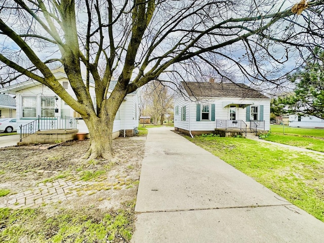 exterior space with driveway and a lawn