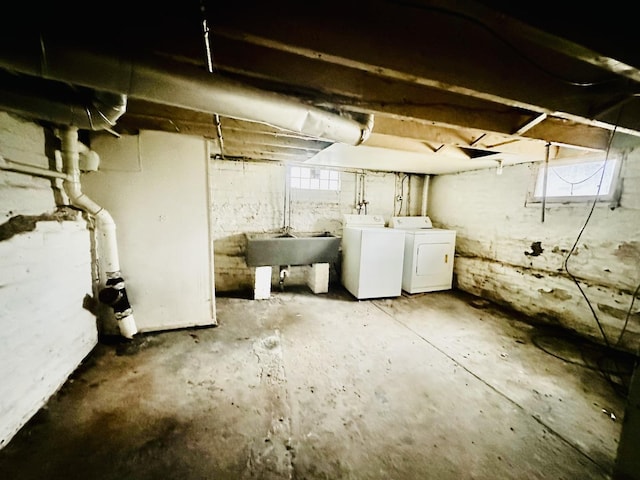 below grade area with a sink and separate washer and dryer