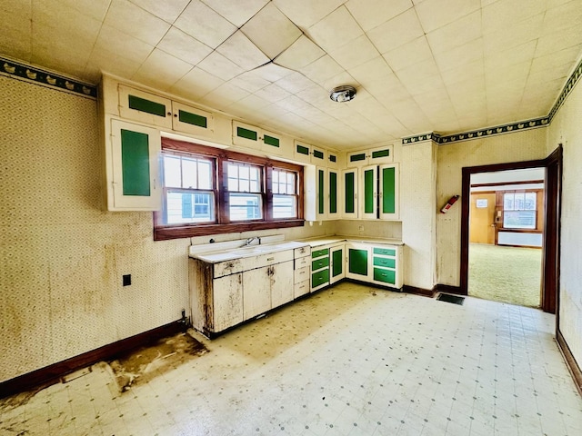 kitchen with light countertops, baseboards, and light floors