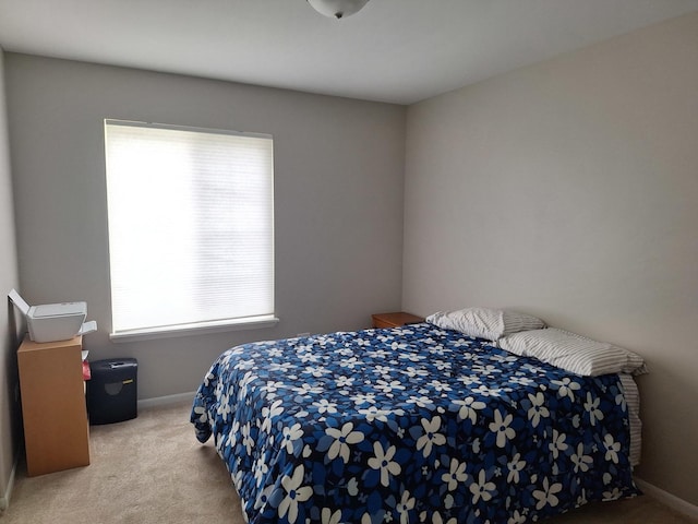 bedroom featuring baseboards and carpet floors