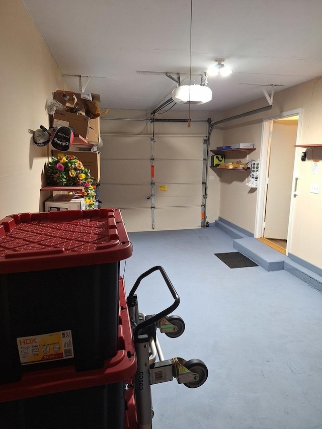 garage with baseboards and a garage door opener