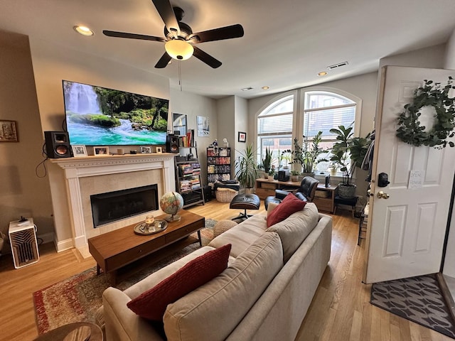 living room with visible vents, a ceiling fan, light wood-style floors, and recessed lighting