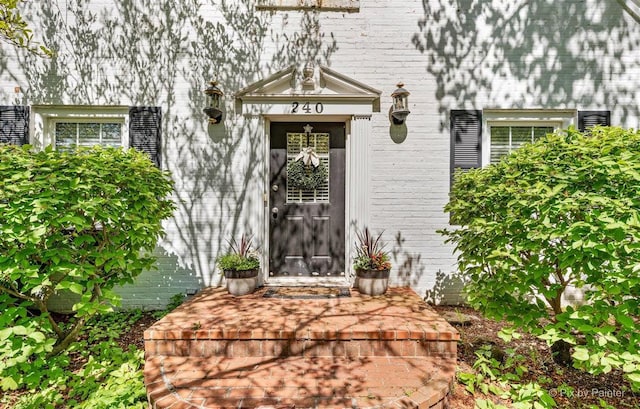 property entrance featuring brick siding