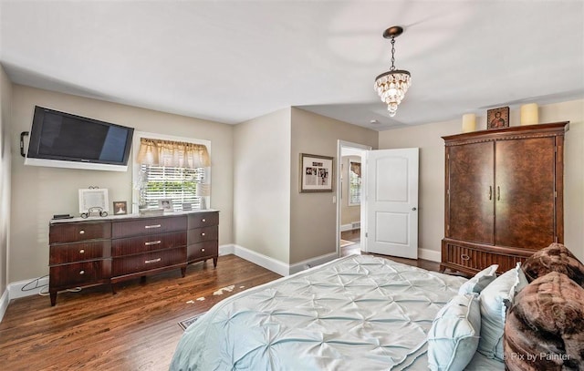 bedroom with baseboards and wood finished floors