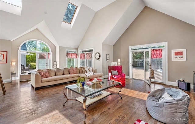 living area with baseboards, high vaulted ceiling, and wood finished floors